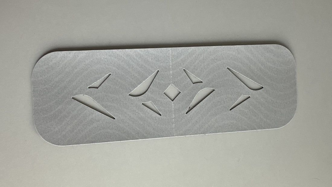 An Easy Kinesiology Tape pre-cut strip on its silver backing paper, showing the wave-pattern fabric and diamond cut-outs before application
