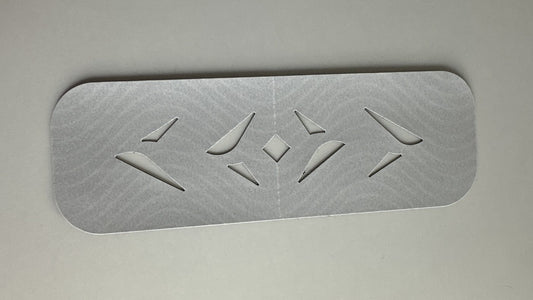 An Easy Kinesiology Tape pre-cut strip on its silver backing paper, showing the wave-pattern fabric and diamond cut-outs before application