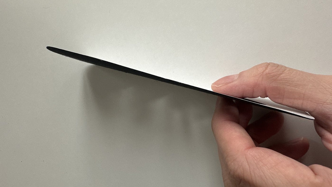 An Easy Tape pre-cut strip held edge-on, showing how flat the strip is