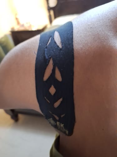 Verified buyer photo — a pre-cut Easy Tape strip with diamond cut-outs applied to the shoulder