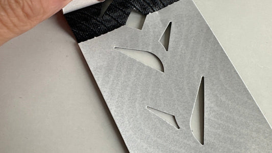 Peeling the die-cut paper backing off an Easy Tape pre-cut strip